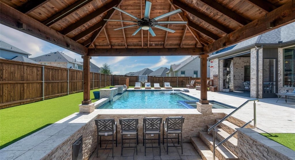 Covered patio and pool with privacy fence by Estrada Fencing