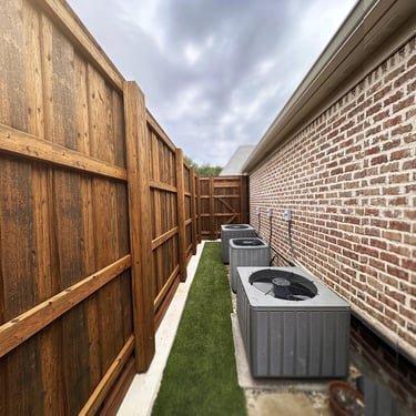 Board-on-board cedar fence along a brick home